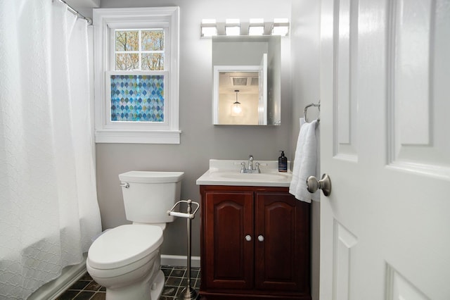bathroom featuring a shower with curtain, tile patterned flooring, vanity, baseboards, and toilet