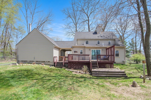 back of property featuring fence, a deck, crawl space, a chimney, and a yard