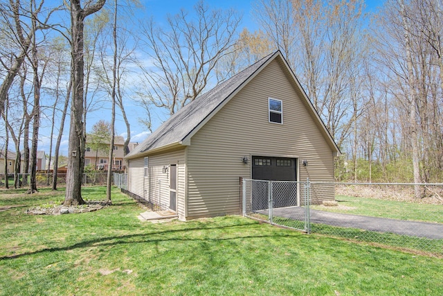 detached garage with fence and driveway