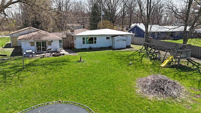 2086 Sloan Rd, Burt, MI 48417 - back of property featuring fence, a yard, a playground, and an outdoor fire pit