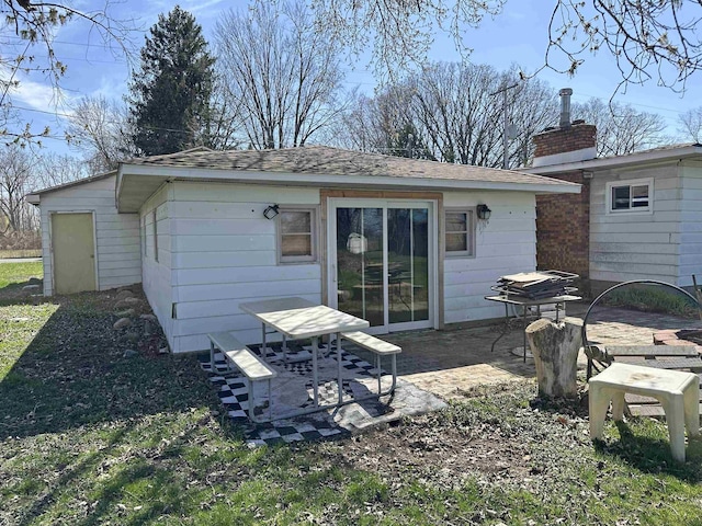 2086 Sloan Rd, Burt, MI 48417 - back of property featuring a patio and a chimney