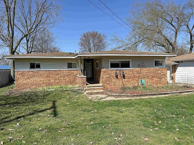 2086 Sloan Rd, Burt, MI 48417 - single story home with a front lawn, fence, and brick siding