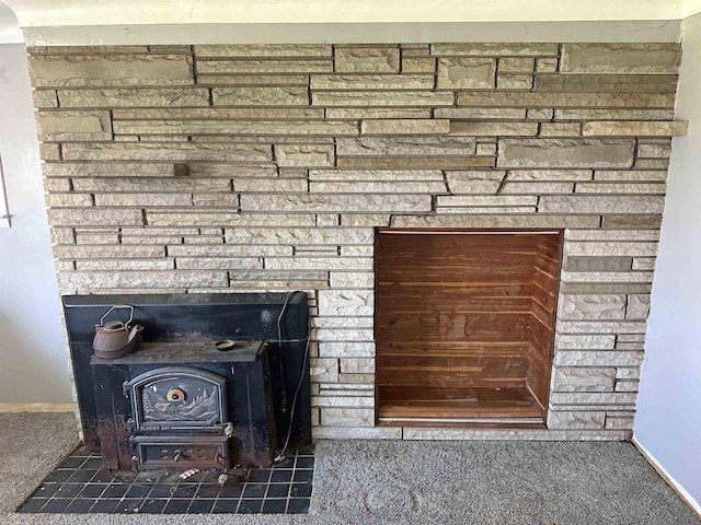 2086 Sloan Rd, Burt, MI 48417 - interior details with baseboards, a wood stove, and carpet flooring