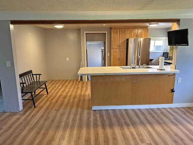 2086 Sloan Rd, Burt, MI 48417 - kitchen featuring light wood finished floors, a sink, freestanding refrigerator, and light countertops