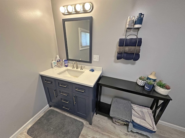 2086 Sloan Rd, Burt, MI 48417 - bathroom featuring wood finished floors, vanity, and baseboards