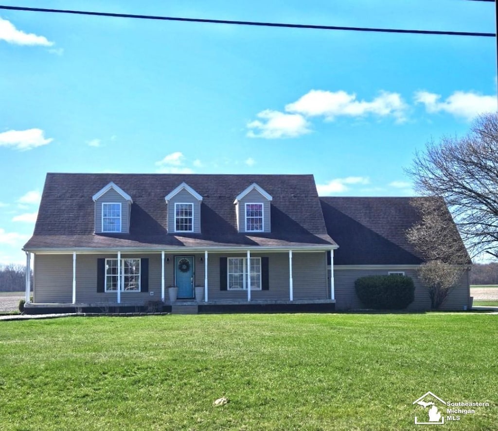 cape cod-style house with covered porch and a front yard