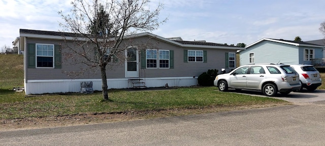view of front facade with a front yard and entry steps