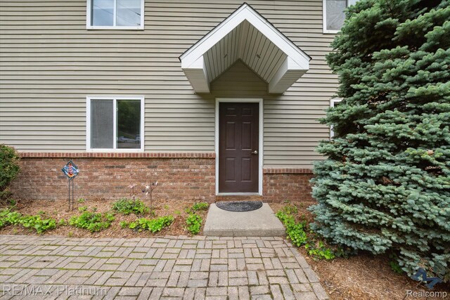11520 Weiman Dr, Pinckney, MI 48169 - doorway to property with brick siding