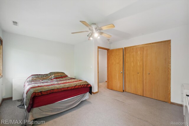 11520 Weiman Dr, Pinckney, MI 48169 - bedroom featuring light carpet, a closet, ceiling fan, and baseboards