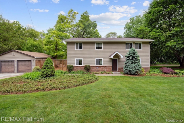 11520 Weiman Dr, Pinckney, MI 48169 - view of front of house with a detached garage, a front lawn, an outdoor structure, and brick siding