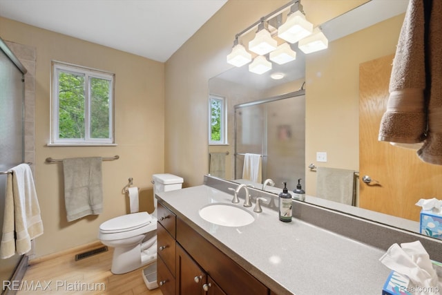 11520 Weiman Dr, Pinckney, MI 48169 - full bath with healthy amount of natural light, wood finished floors, an enclosed shower, and vanity