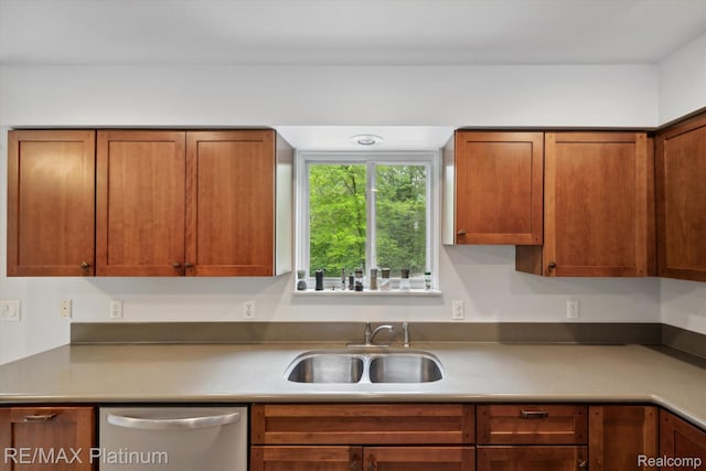 11520 Weiman Dr, Pinckney, MI 48169 - kitchen featuring stainless steel dishwasher, a sink, and brown cabinetry