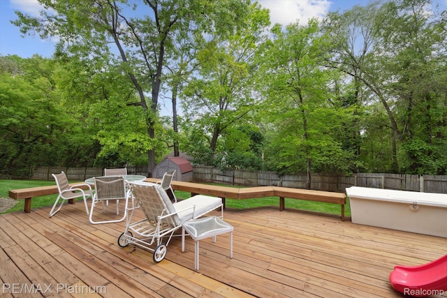 11520 Weiman Dr, Pinckney, MI 48169 - wooden deck featuring a fenced backyard, outdoor dining space, and view of scattered trees