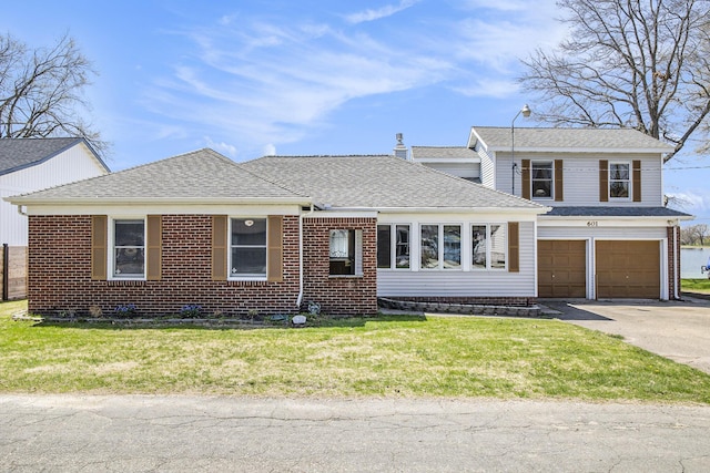 view of front of house featuring brick siding, aphalt driveway, a shingled roof, a front lawn, and an attached garage