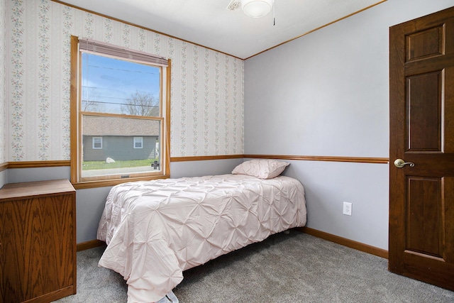 bedroom featuring baseboards, wallpapered walls, crown molding, and carpet flooring
