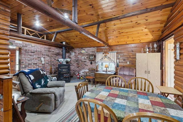 3895 Pine St, Glennie, MI 48737 - dining area featuring a wood stove, lofted ceiling, brick wall, log walls, and wooden ceiling