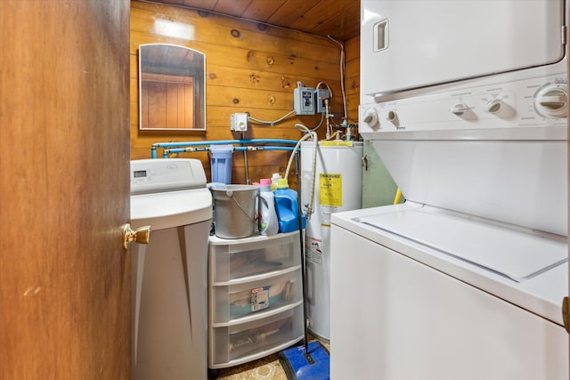 3895 Pine St, Glennie, MI 48737 - laundry area featuring stacked washer / dryer, electric water heater, wooden ceiling, and wood walls