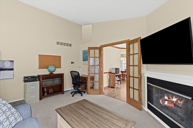514 Mill Pond Dr, Fenton, MI 48430 - interior space with baseboards, visible vents, french doors, and a warm lit fireplace