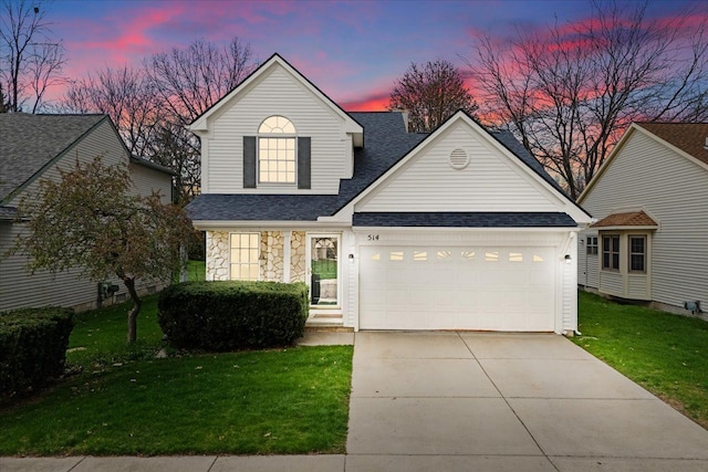 514 Mill Pond Dr, Fenton, MI 48430 - traditional-style home featuring driveway, stone siding, a shingled roof, a front yard, and an attached garage