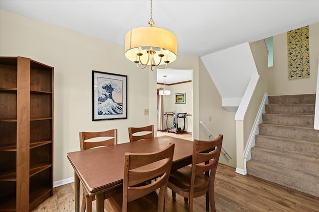 514 Mill Pond Dr, Fenton, MI 48430 - dining space featuring an inviting chandelier, stairway, wood finished floors, and baseboards