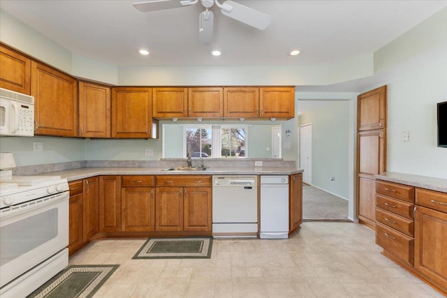 kitchen featuring a sink, white appliances, brown cabinetry, a ceiling fan, and light countertops