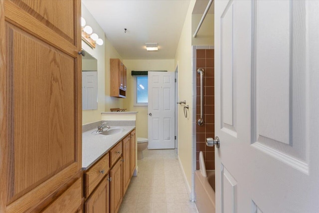 bathroom with baseboards, toilet, and vanity