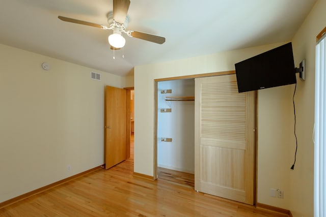 unfurnished bedroom with ceiling fan, visible vents, baseboards, a closet, and light wood-style flooring