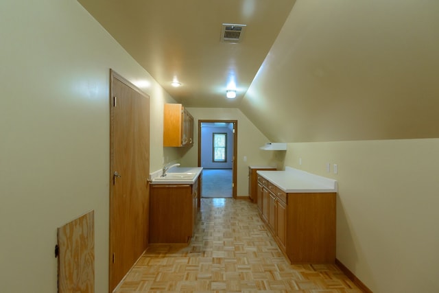 interior space with baseboards, visible vents, and a sink