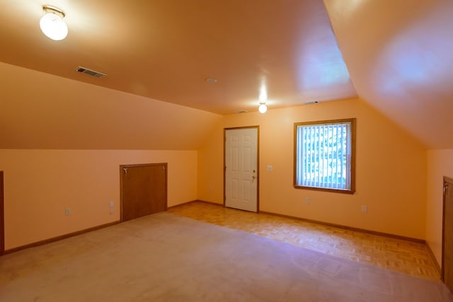 bonus room featuring baseboards, visible vents, and lofted ceiling