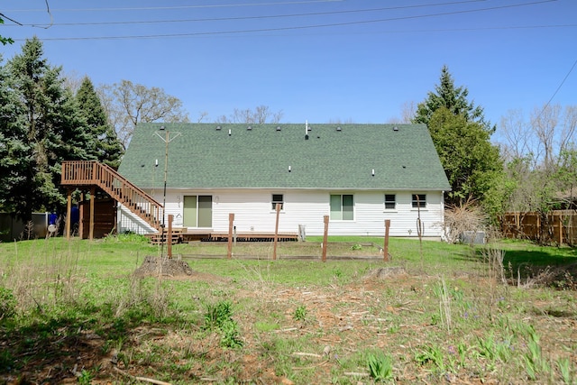 back of property featuring stairway, fence, a wooden deck, and a shingled roof