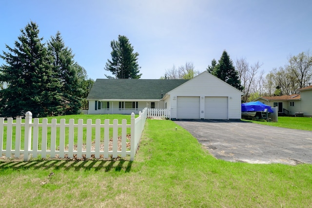 ranch-style house with aphalt driveway, an attached garage, fence private yard, and a front yard
