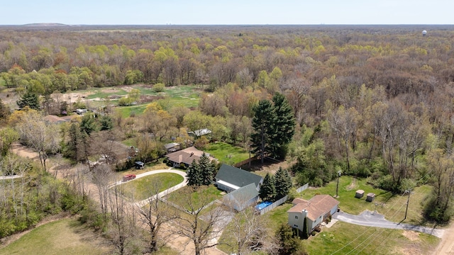 bird's eye view with a wooded view