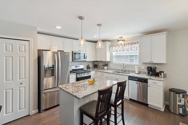 kitchen featuring stainless steel appliances, white cabinetry, and a sink