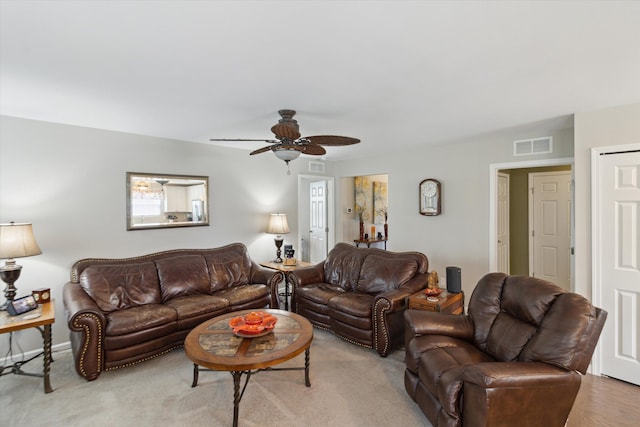 living area featuring ceiling fan and visible vents
