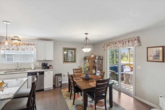 dining space featuring baseboards and dark wood-style floors