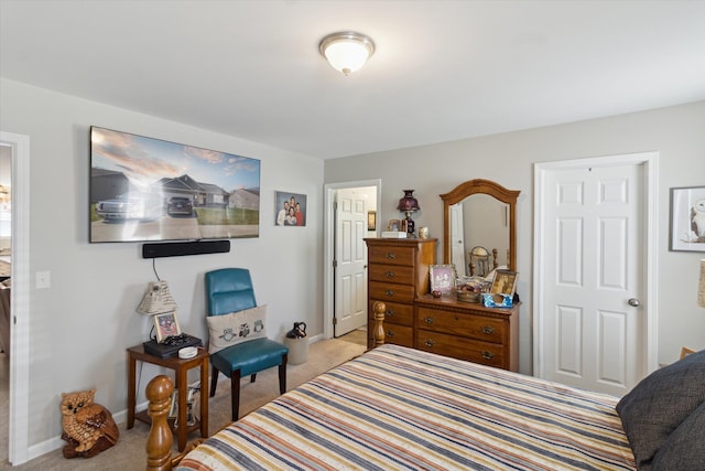 bedroom featuring baseboards and carpet