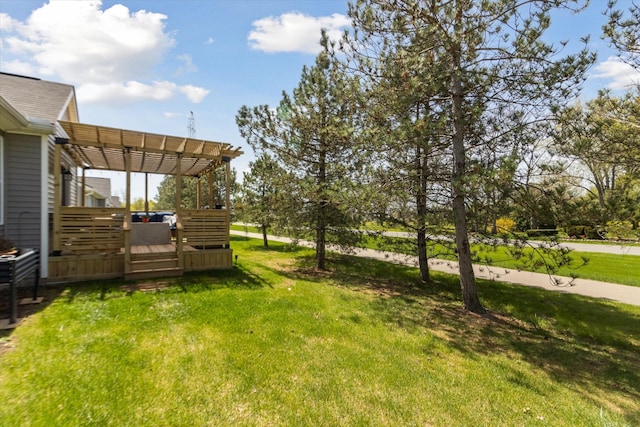view of yard featuring a deck and a pergola