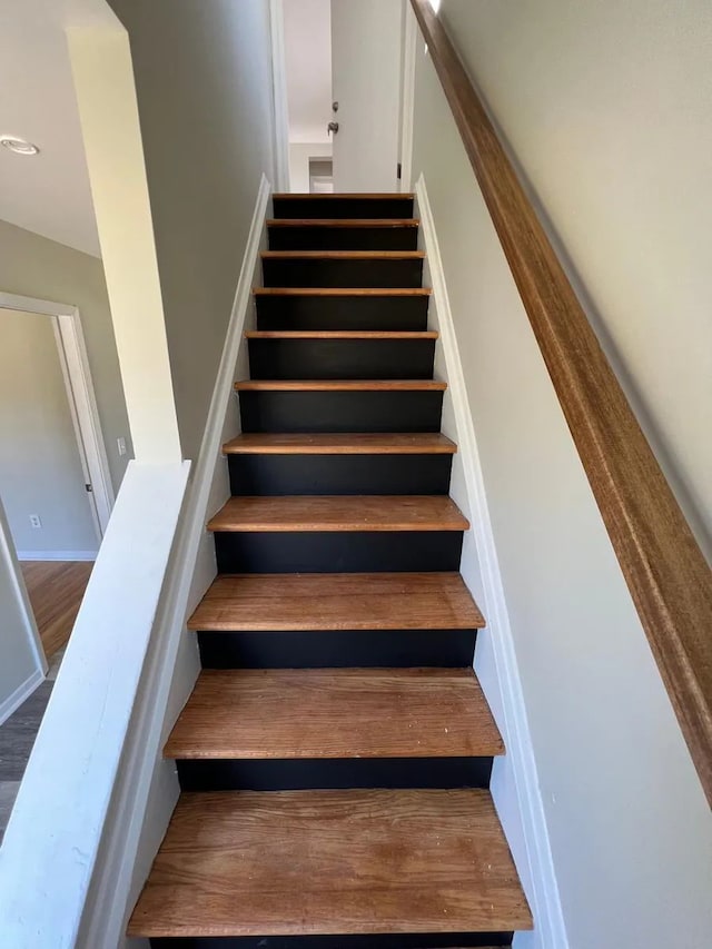 staircase featuring wood finished floors