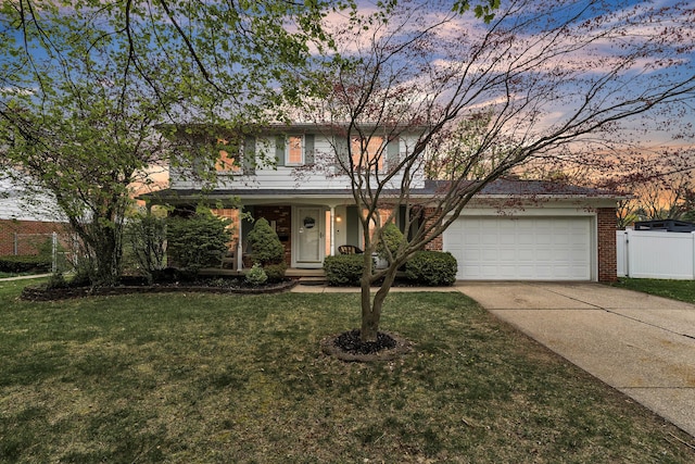 traditional-style house featuring concrete driveway, fence, an attached garage, and brick siding