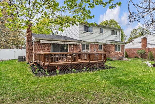 rear view of property with a deck, a yard, a fenced backyard, and central AC unit