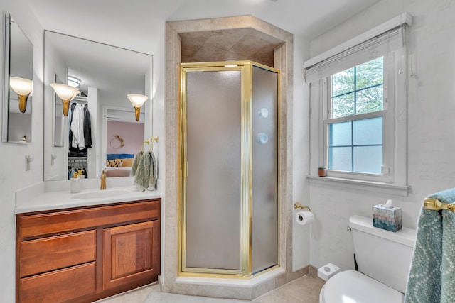 full bathroom featuring vanity, toilet, tile patterned flooring, and a stall shower