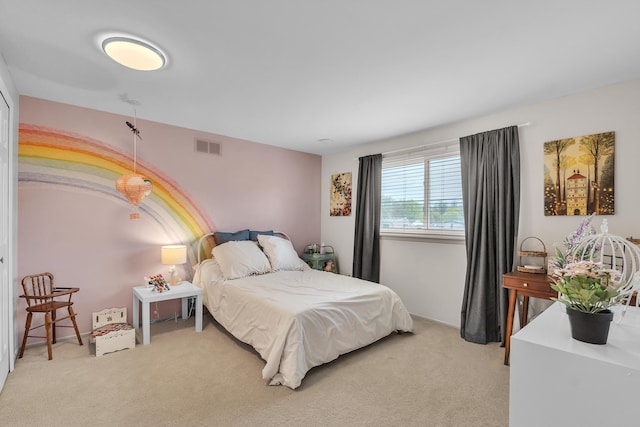 bedroom featuring visible vents and light colored carpet