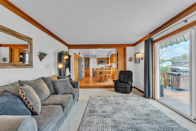 living room featuring crown molding, light colored carpet, and baseboards