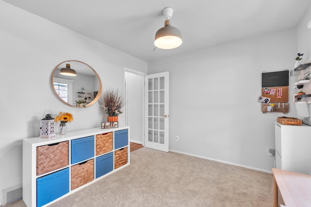rec room featuring visible vents, light colored carpet, and baseboards