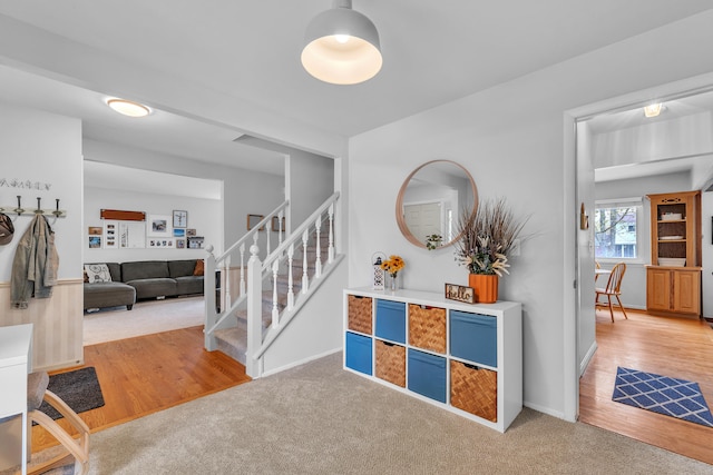 interior space with stairway and baseboards