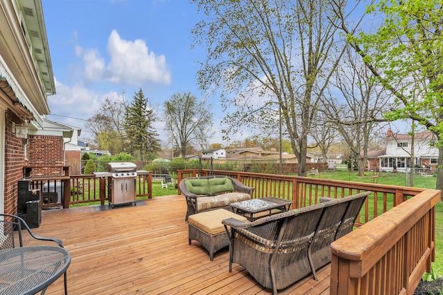wooden terrace with a residential view, a fenced backyard, a lawn, area for grilling, and an outdoor hangout area