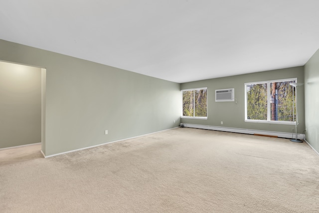 unfurnished room featuring baseboards, a baseboard radiator, an AC wall unit, and light colored carpet