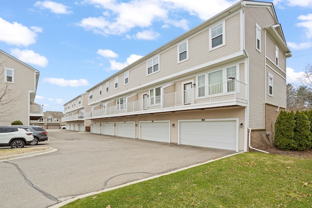 exterior space with a front yard and community garages