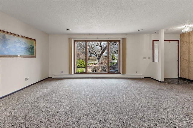 carpeted spare room with baseboards and a textured ceiling