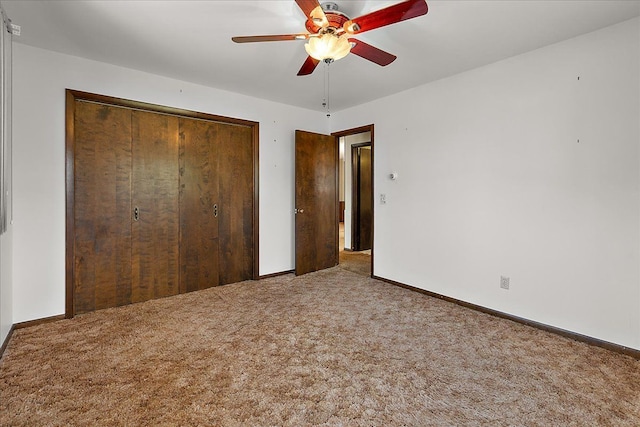 unfurnished bedroom with a closet, baseboards, a ceiling fan, and carpet flooring